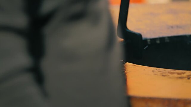 A close-up of grilled meat slices searing on the shiny, blackened surface of the grill. The meat glistens with juices, revealing a deliciously golden crust and tenderness