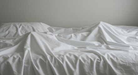 A wide shot of deeply wrinkled white bedding and sheets, resembling mountains and valleys in a stark, comfortable landscape ,shadow ,curve ,pattern