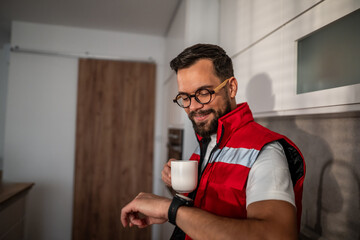 Man checking smartwatch during coffee break