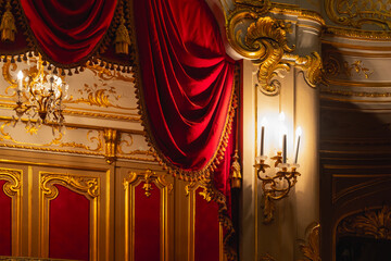 Luxurious theater box interior featuring gilding, ornate moldings and red velvet © evannovostro