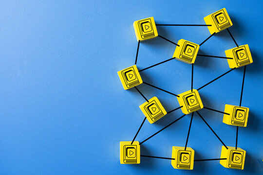 E-learning and online education concept. A network of digital content and video course icons, symbolizing a knowledge-sharing system and technology platform on a blue background with copy space.