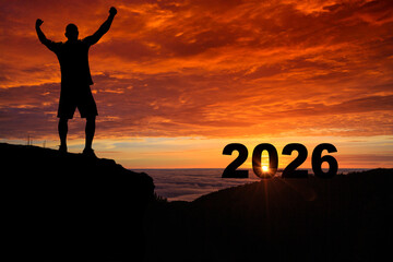 Man silhouette on the mountain top watching the sunrise of the new year 2026 , Highlighting New Year Dreams and New Goals