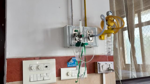 closeup of hospital bedside oxygen and suction equipment