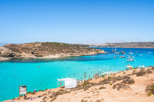 Panorama of the cliff coast with Blue Lagoon, Cominotto beach and Gozo island in the background, Comino MALTA 