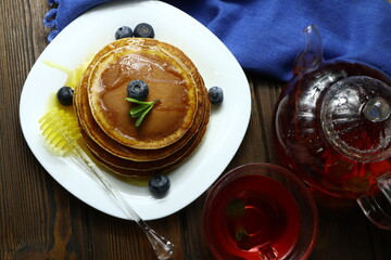 Tasty homemade pancakes with honey and berries