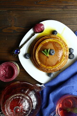 Tasty homemade pancakes with honey and berries