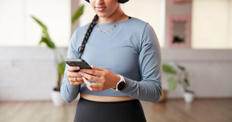 Phone, hands and woman at pilates class with networking, communication or social media on mobile app. Technology, fitness and person at yoga session with cellphone for texting, research or chatting.