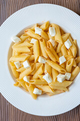 Close-Up of Penne Pasta with Cubed Cheese