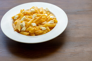 Close-Up of Penne Pasta with Cubed Cheese