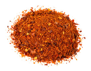 Pile of chili flakes vibrant red spice on a white surface
