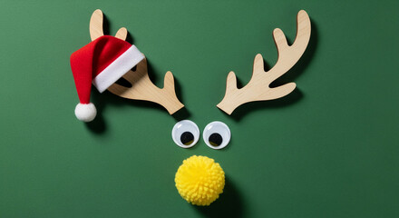 Festive reindeer face with wooden antler, googly eyes, yellow pompom nose, and red Santa hat, symbolizing holiday cheer and Christmas celebration