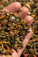a large amount of dried green tea with the addition of natural flavors and pieces of fruits and berries