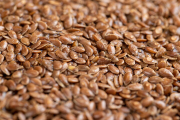 wet flax seeds are used to produce food or germinate for dietary nutrition, covered with drops of water, a large amount of light brown flax seeds