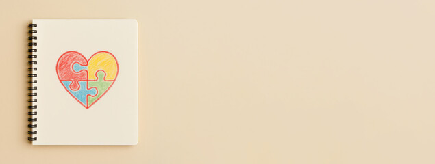 Autism Awareness Day puzzle heart drawing on beige background