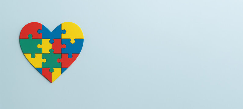 Autism Awareness Day heart-shaped puzzle concept on pale blue background