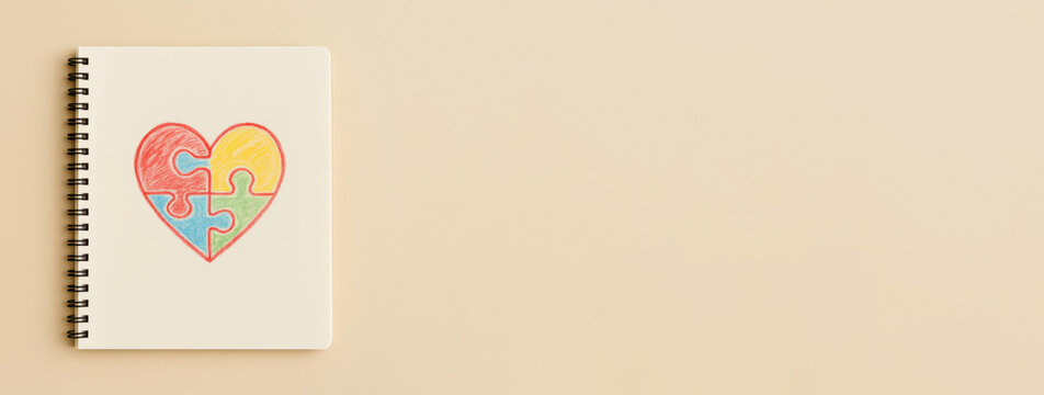 Autism Awareness Day puzzle heart drawing on beige background