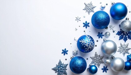 A festive arrangement of shiny blue and silver Christmas ornaments and intricately designed snowflakes scattered on a white background. The composition evokes a winter holiday atmosphere with elegance