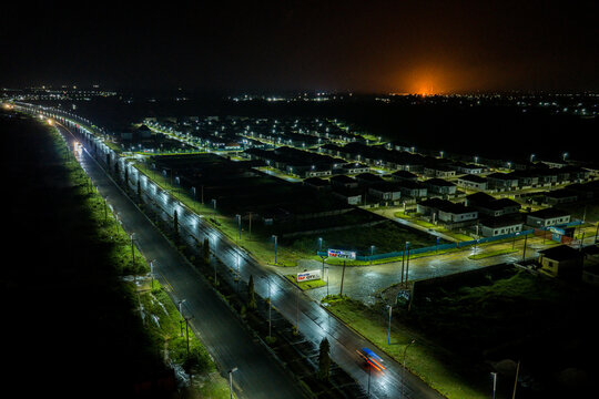 Aerial view of illuminated streets cutting through the dark landscape and neat rows of houses under the night sky, Port Harcourt, Rivers, Nigeria.