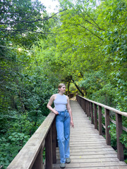 Fototapeta premium young pretty girl/woman walking in the woods