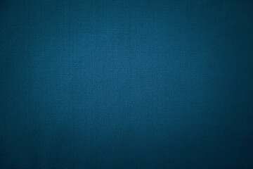 Detailed texture of dark blue woven fabric with a slight vignette effect.