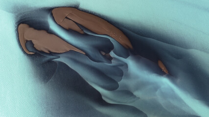 Aerial view of glacial rivers carving through the Icelandic landscape, where turquoise waters meet earthy sand deposits, creating a mesmerizing contrast, Landmannalaugar, Rangarbing ytra, Iceland.