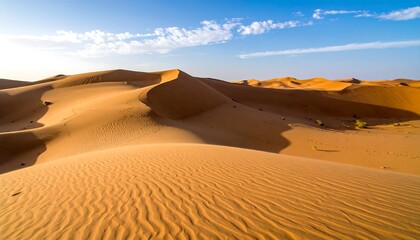 Serene desert landscape with rolling sand dunes under a clear blue sky.