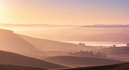 Golden sunrise over rolling hills and misty valley