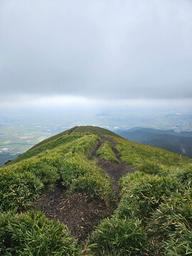 Beautiful landscape of the mountain range in Daikanbo the peak in Mount Aso Japan with cloudy sky