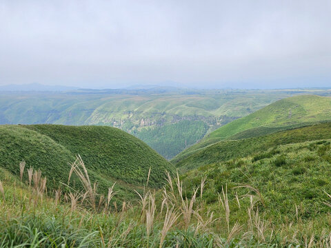 Beautiful landscape of the mountain range in Daikanbo the peak in Mount Aso Japan with cloudy sky