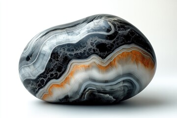 Obraz premium A polished, multi-banded agate or onyx stone showcases natural black, grey, white, and striking orange layers. Its smooth, rounded form highlights intricate geological patterns.