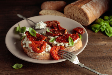 Ciabatta with sun dried tomatoes in olive oil, ricotta, and basil.