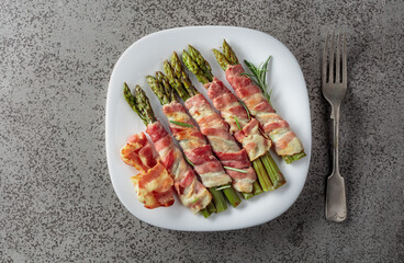 Grilled green asparagus wrapped in bacon.