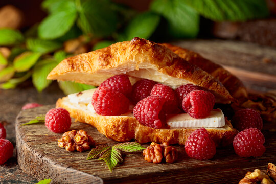 Croissant with camembert cheese, raspberries and walnuts.