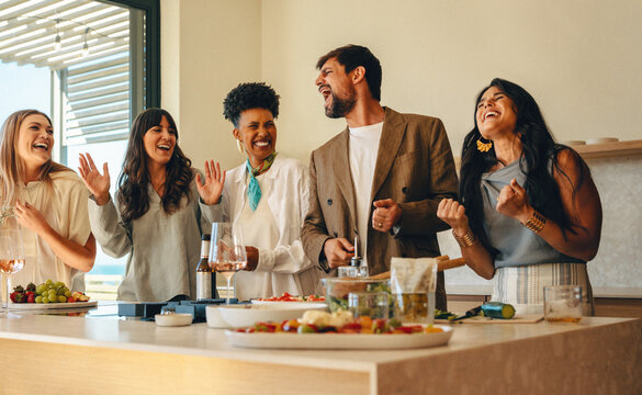 Friends enjoying a dinner party with laughter and good vibes