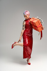 Festive winter wonderland moment with a beautiful young woman and her cheerful gift