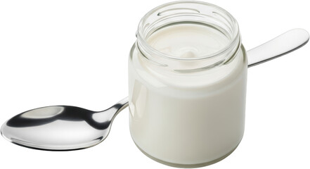 A single glass jar filled with thick white yogurt with a shiny metal spoon resting beside it Isolated with Food Dairy Creamy Fresh Healthy Breakfast Dessert