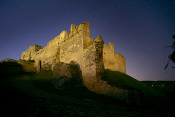 View of the ancient Beckov Castle ruins stand majestically against the starlit sky, a testament to time and history, Beckov, Trencin Region, Slovakia.
