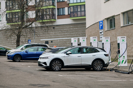 Minsk, Belarus. Jan 19, 2025. VW electric car charging. Electric vehicles plugged into charging station in parking lot, modern technology and sustainable energy use. E-SUV charging battery