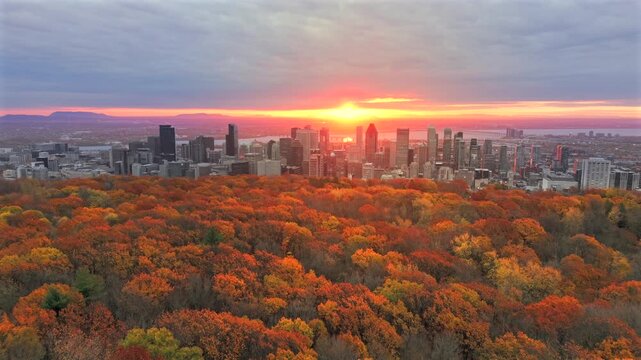 Drone sunrise aerial view of Montreal skyline with autumn foliage