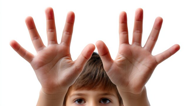 Child shows enthusiasm with hands raised wide, fingers spread apart against a plain background