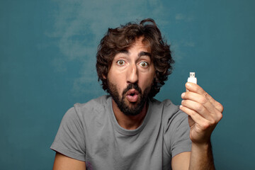 young adult bearded man with a usb memory