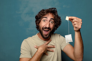 young adult bearded man with an infusion of tea