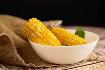 warm corn in a bowl with basil on top
