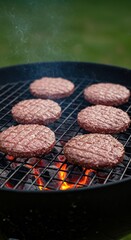 Delicious homemade cheeseburger patties sizzling intensely over hot charcoal briquettes on an outdoor backyard barbeque grill ,hamburger ,barbeque ,meat