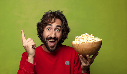 young adult bearded man. popcorns and movie concept