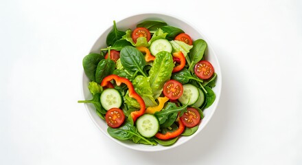 Fresh, vibrant salad in a white bowl, top view, featuring spinach, tomatoes, and cucumbers