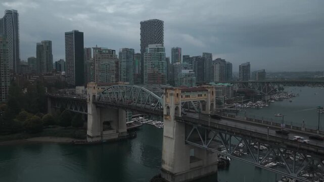 Aerial close-up panning shot of Burrard Bridge during rainy weather in Vancouver, British Columbia, Canada. 4K
