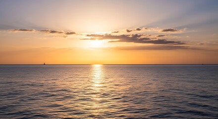 Obraz premium Golden Sunset Over Calm Ocean Waters with Reflective Sunlight.