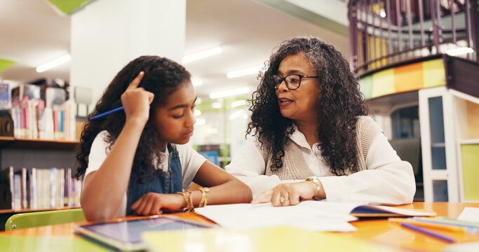 Teacher, student and lesson with books in library with reading evaluation, literature and problem solving. Tutor, child and education with help for assessment, learning support or study assistance