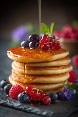 Golden Stack of Fluffy Pancakes Drizzled with Honey, Topped with Fresh Berries and Mint.